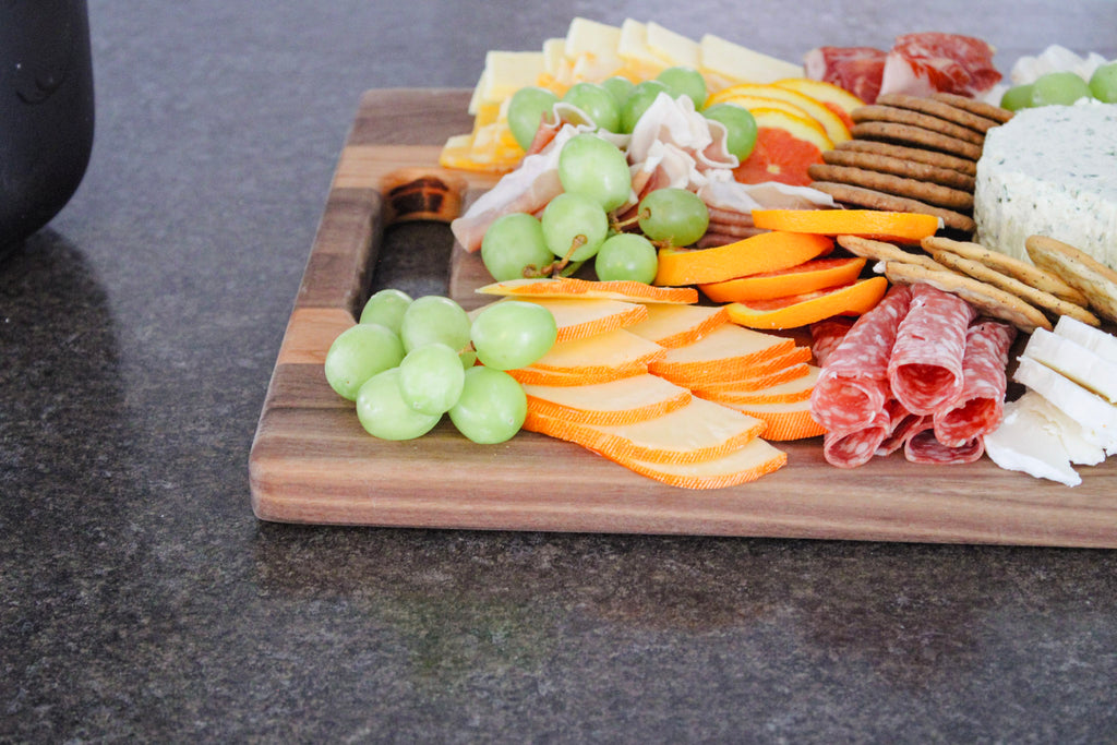 Close up shot of the styled charcuterie board that is sitting on  a kitchen counter.