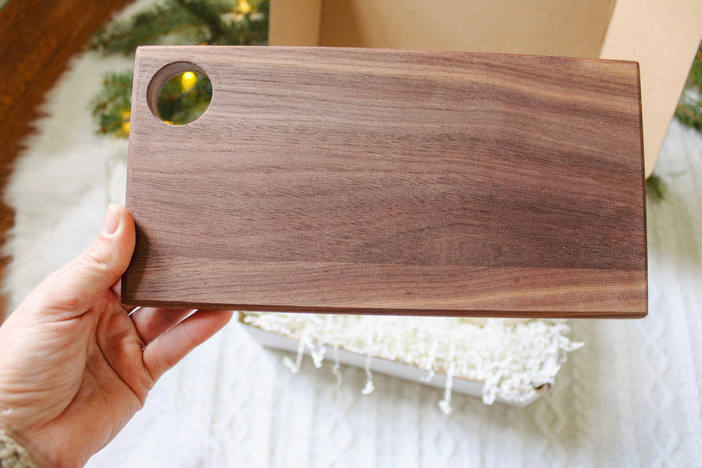 Close up image of the wooden cheese board in the coffee lover's gift box.