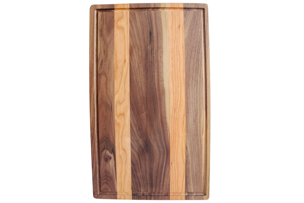 Handmade wooden cutting board with the background removed.