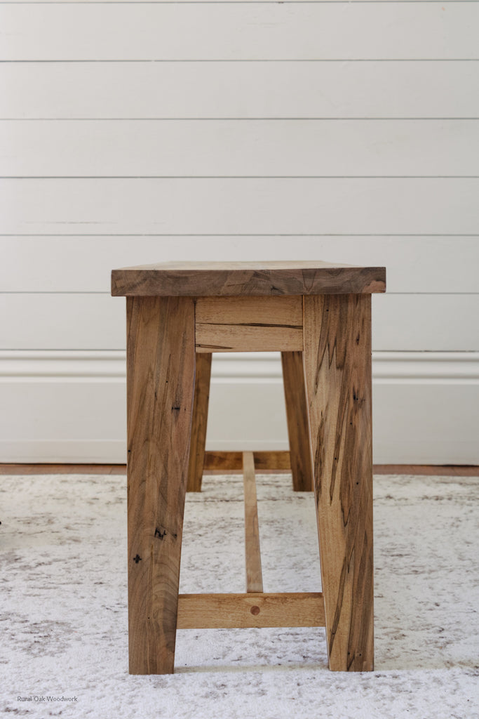 Side image of the homestead bench. Featuring the detail of the beautiful angled legs.