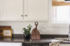 Wooden cutting board sitting on a kitchen counter.