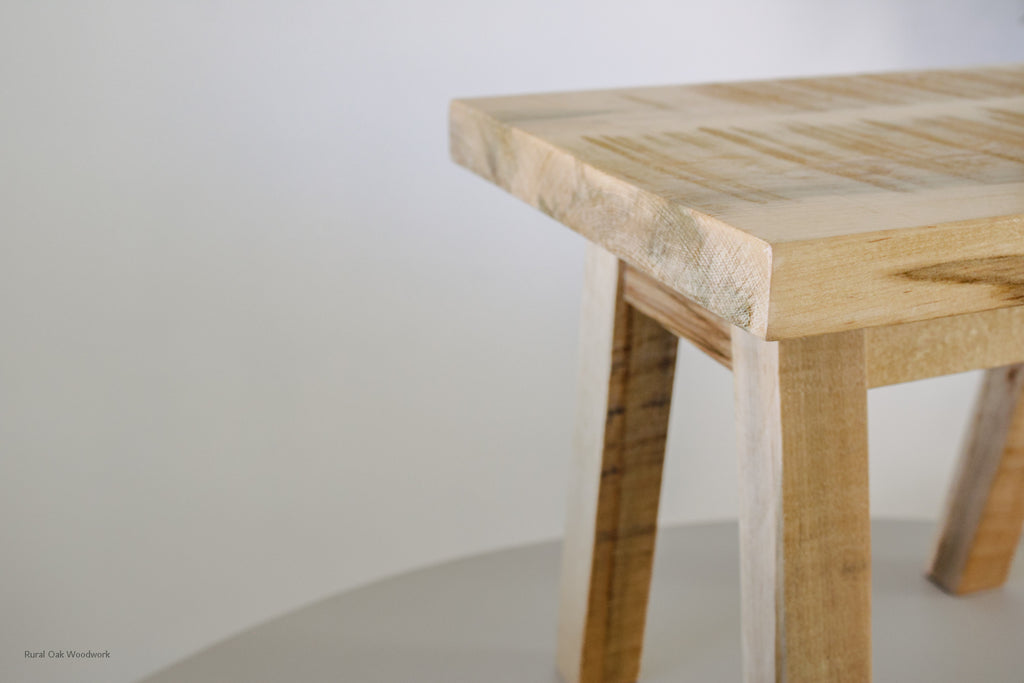 Close up shot of the step stool showing off the beautiful wormy maple wood grain.