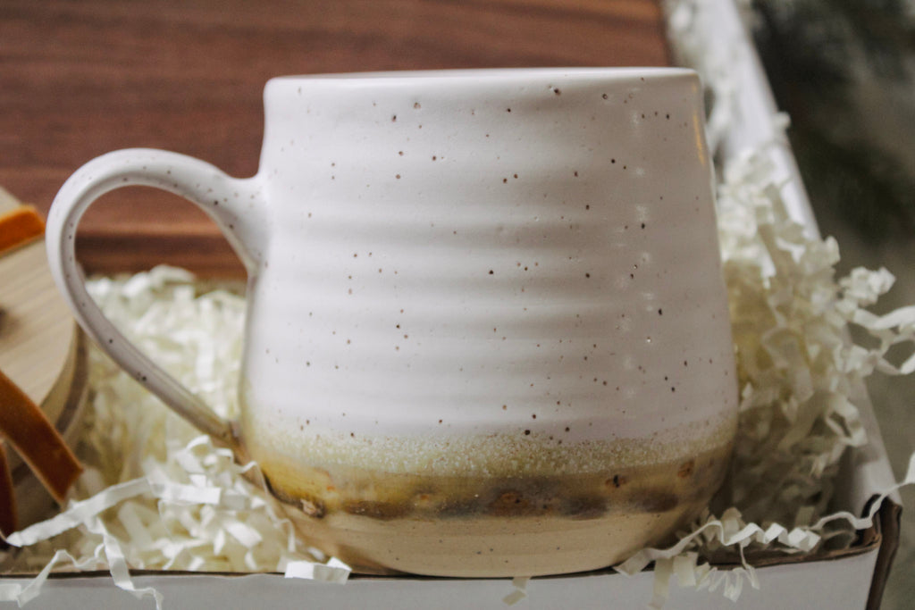 Close up image of the pottery mug in the coffee lover's gift box.