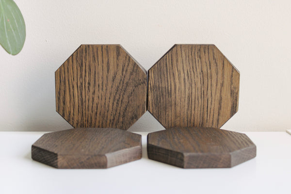 Four wooden octagon coasters.