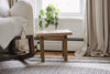 Rustic step stool styled beside a cream rocking chair in front of a window.