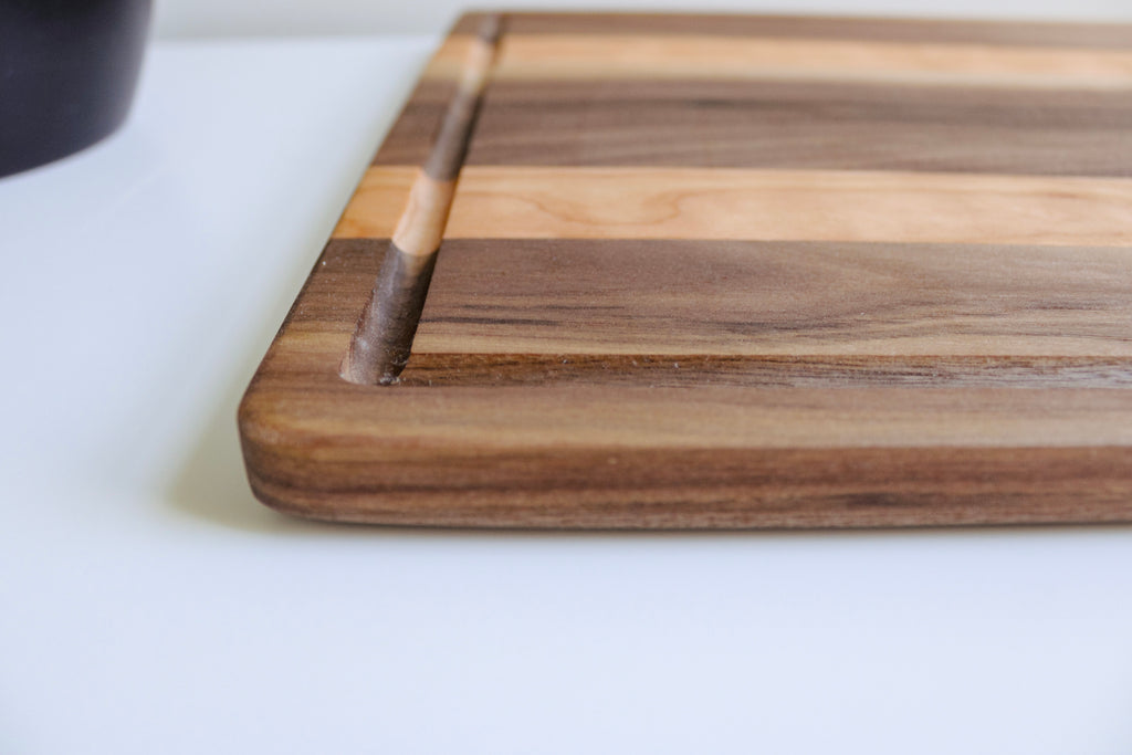 Close up image showing the detail of the grooved boarder of the cutting board.